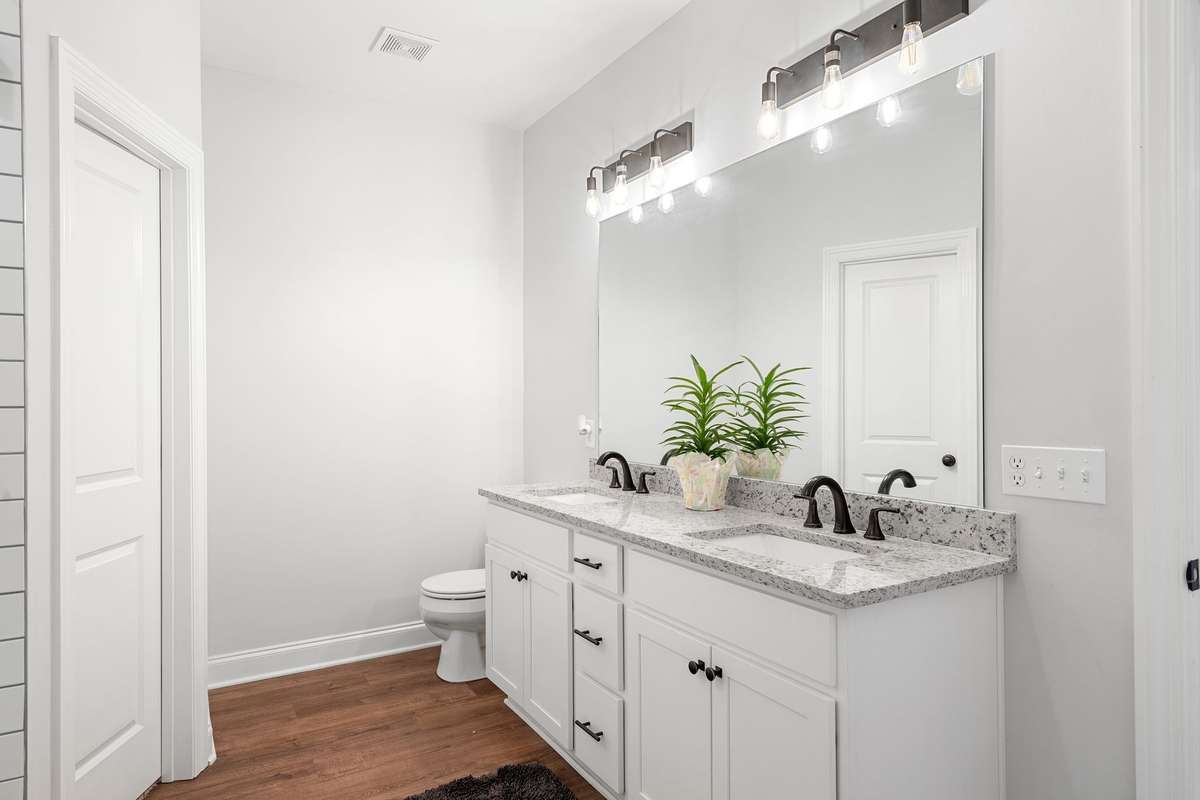Primary suite- white cabinets and great lightening.