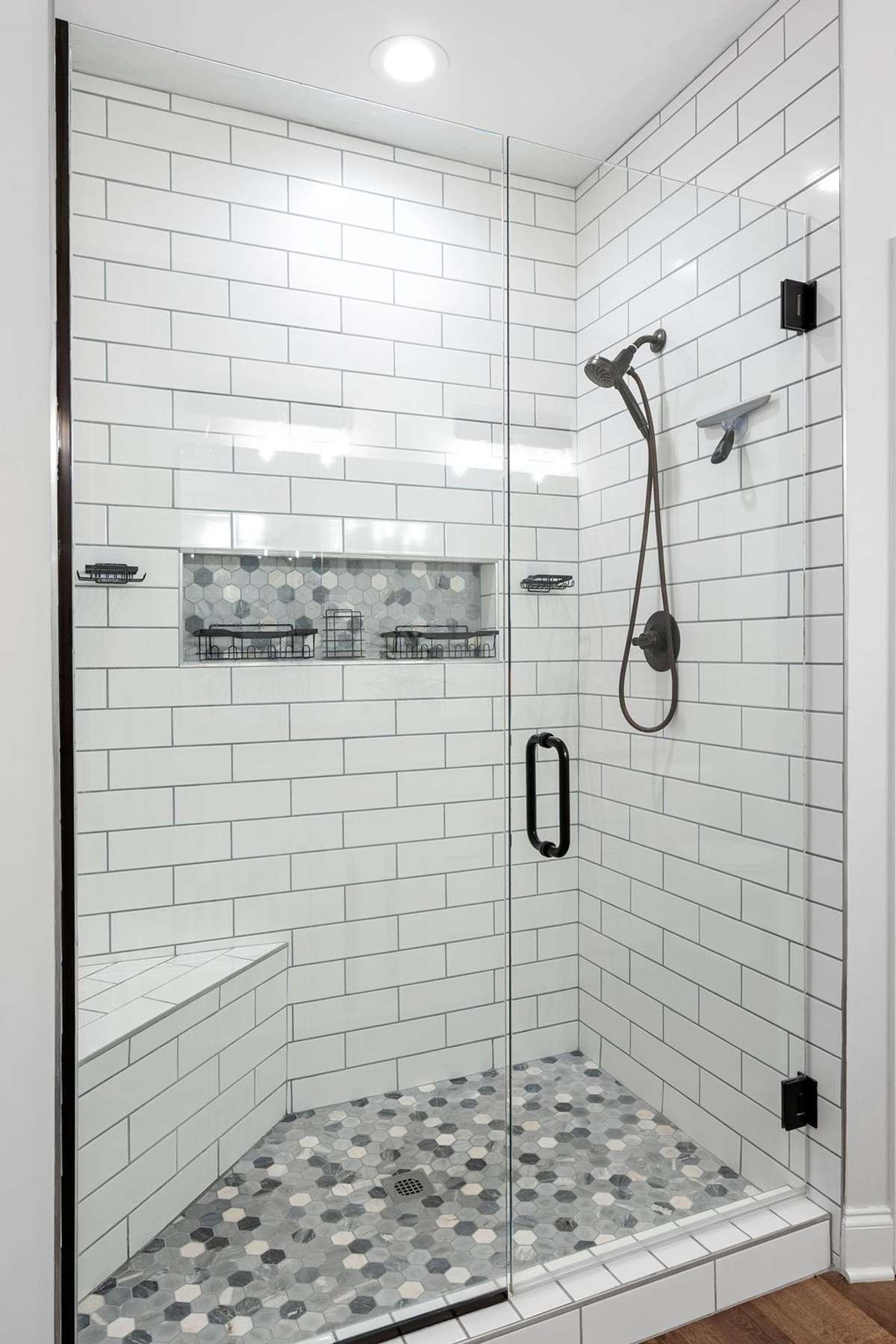 Closer view of renovate shower. Original shower had no glass, basic shower fixtures, and fiber insert.