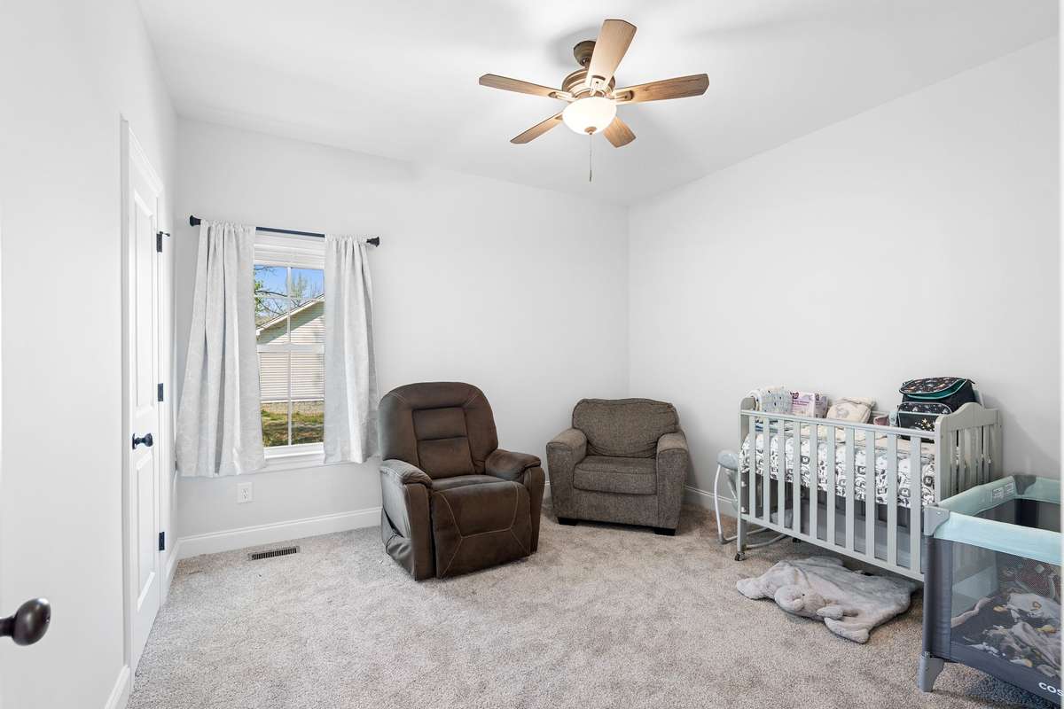 3rd Bedroom at the back of the house with views into the backyard. This room features ceiling fan and walk-in closet.