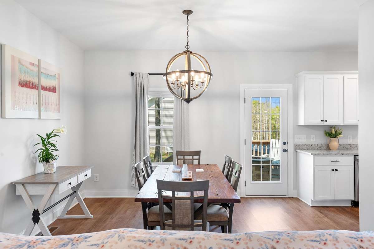 Generously sized dining space with views on the back deck and into the kitchen, making it ideal for entertaining.