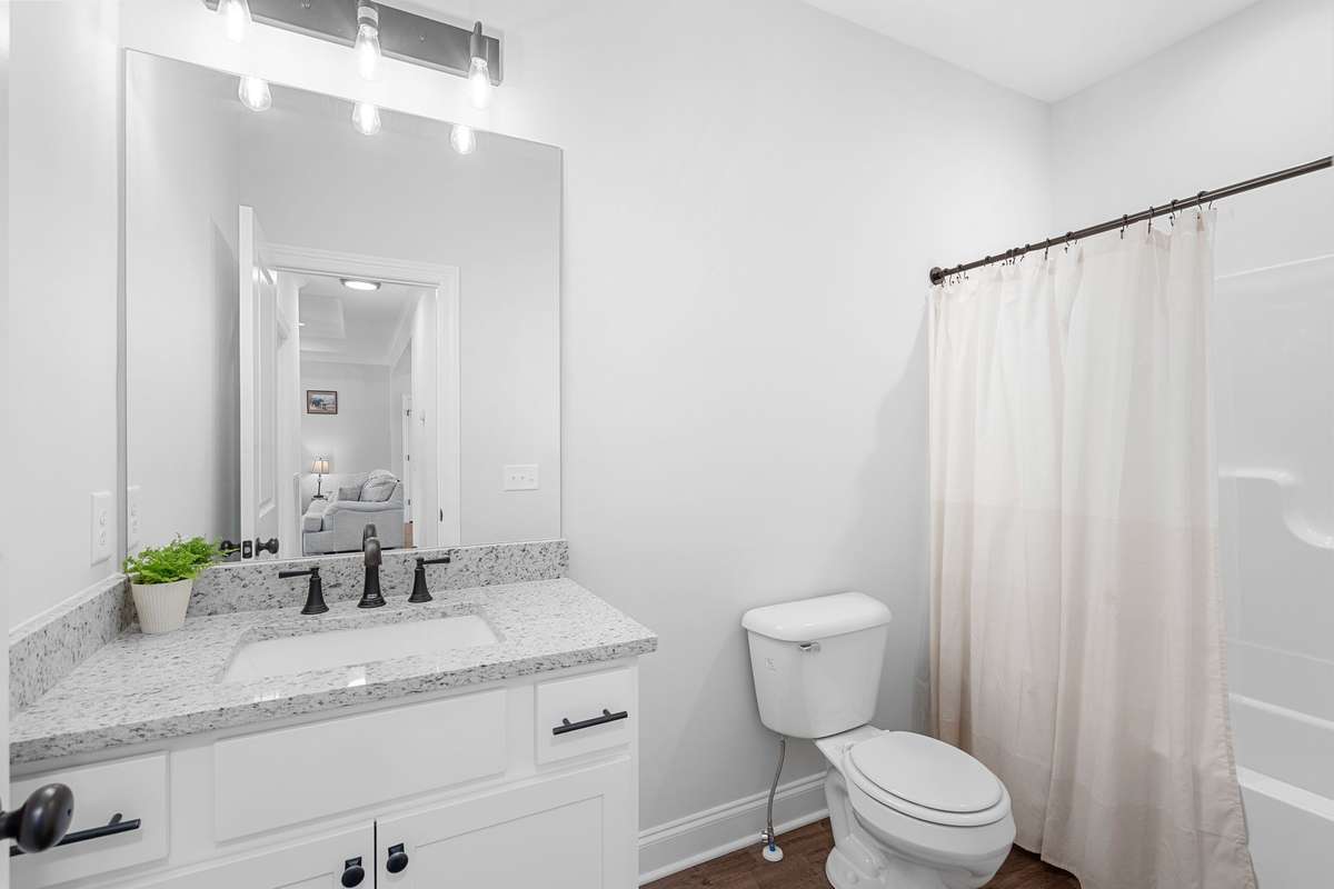 2nd Full Bathroom featuring granite countertops, white cabinets, and combination tub/shower.
