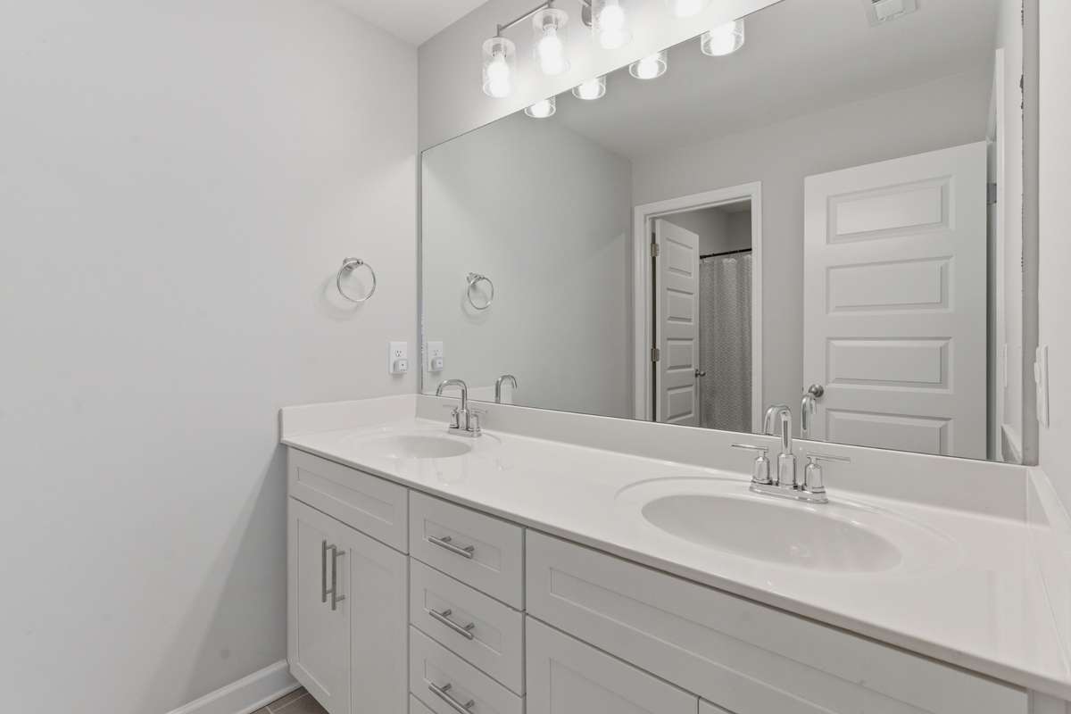 Upstairs full bathroom with double vanities