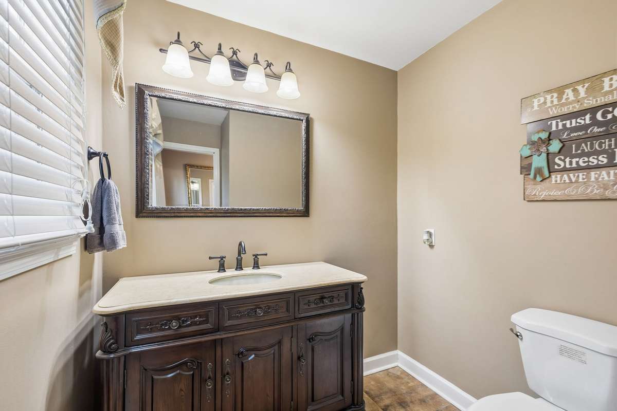 This half bath tucks neatly off the main level with a window that brings in natural light during the day.