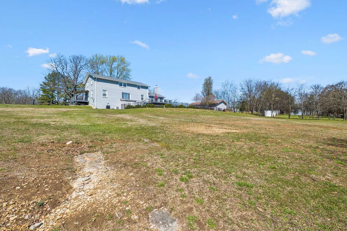 Rolling yard stretches out over the 17 wooded acres with established trees framing the property and room for future landscaping or recreational activities.