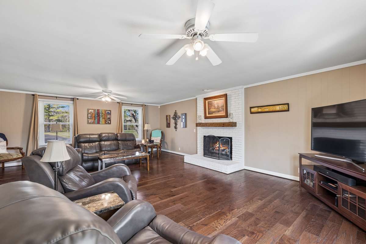 This family room gives you enough space to arrange multiple seating areas while keeping the fireplace as the natural focal point for evening conversations.