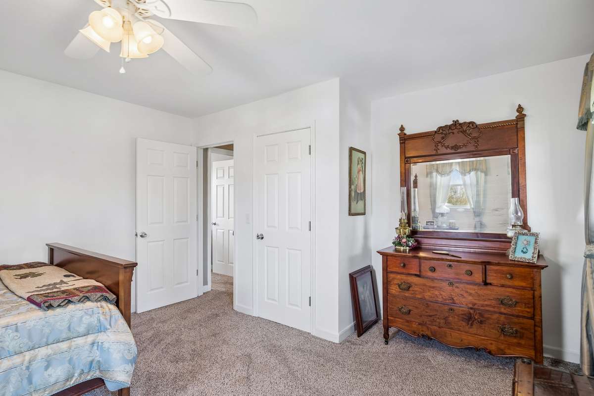 Wide open floor plan on this bedroom level with vintage furnishings and an ornate wooden dresser that brings character to the corner space.