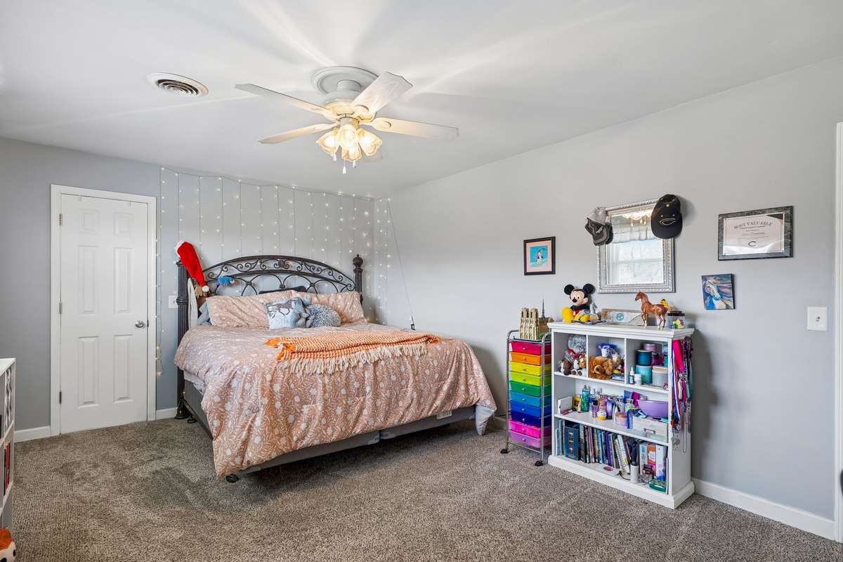 Organized storage with colorful drawers, built-in shelving for books and games, and wall space that shows off artwork and memories.