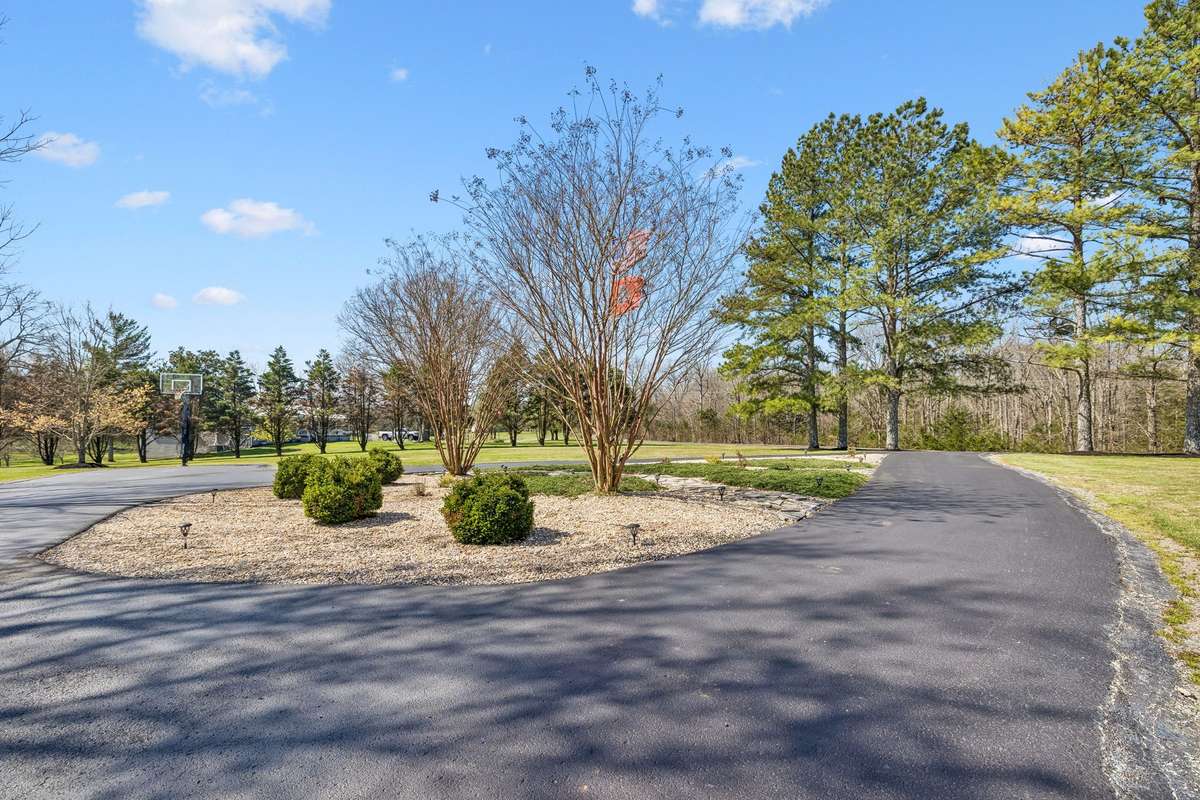Circular driveway with a landscaped center island creates an impressive approach to this Christiana home while providing easy turnaround access.