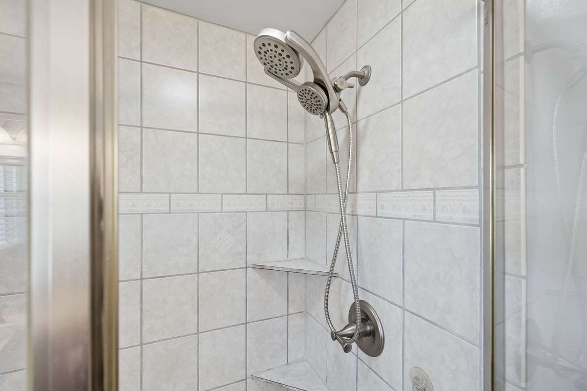 Dual showerhead setup with handheld and fixed options keeps the morning routine flexible.