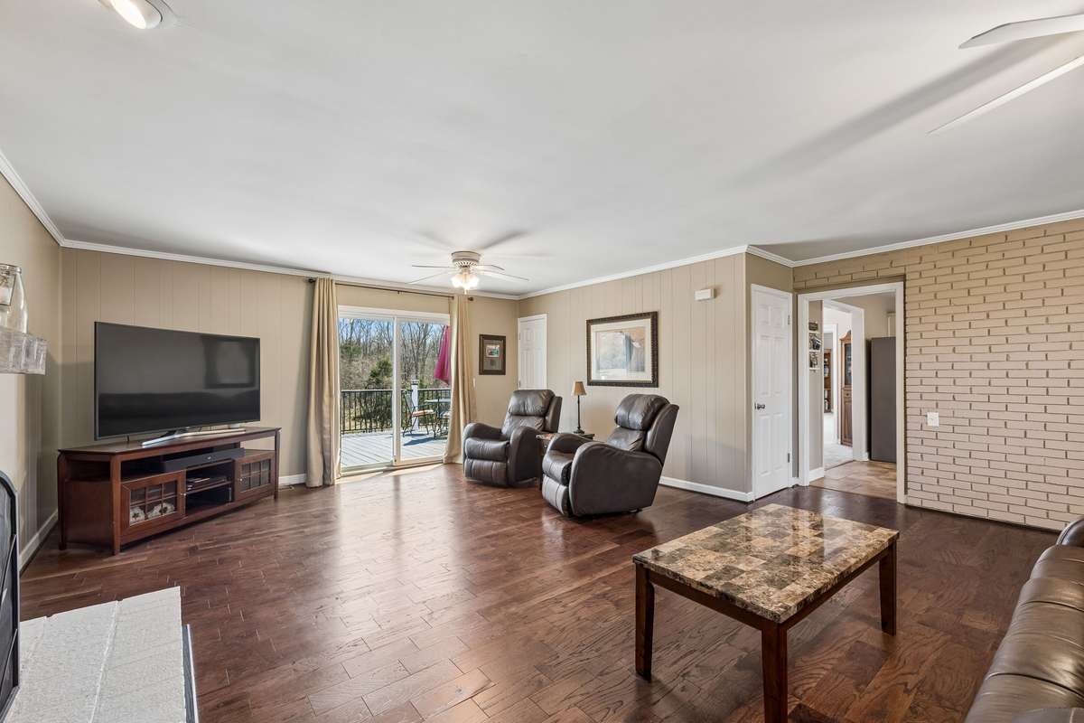 Painted brick accent wall and hardwood floors give this family room a warm, finished feel that's comfortable without being too formal.