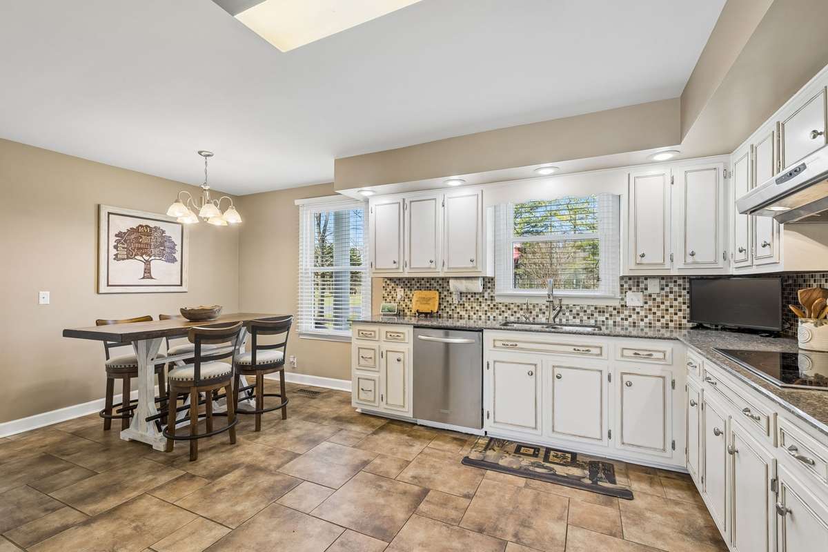 The breakfast nook tucks into the corner with enough room for casual meals while staying connected to the kitchen workflow.