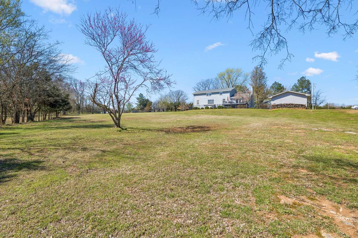 Seventeen acres of rolling land with mature trees provide privacy and room for outdoor activities beyond the house.