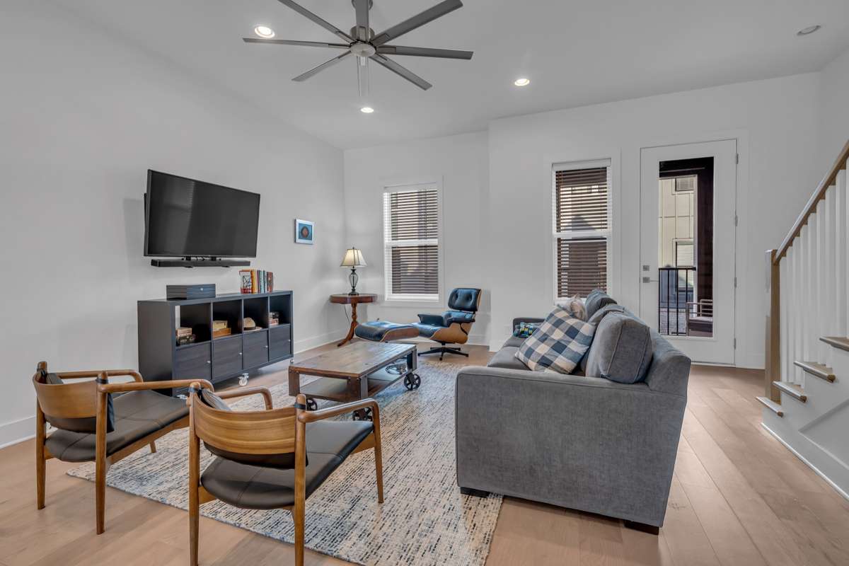 The living room has ample space while still leaving room for a path of travel to the dining and kitchen areas.