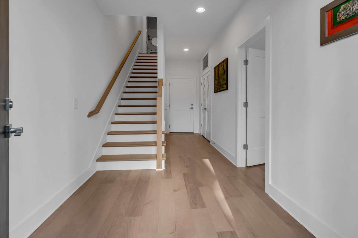 As you enter, the first bedroom is on your right, and the garage door is straight ahead.