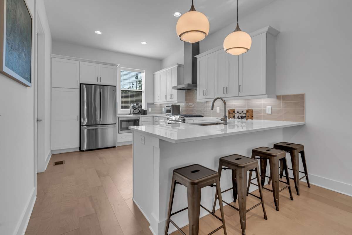 The U-shaped kitchen provides plenty of countertop and storage space, as well as an eat in island.