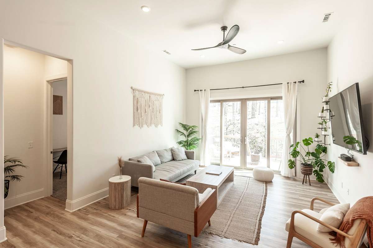 Centrally located in the home is this spacious living area, with large sliding doors leading to the back deck, allowing ample natural light into the open floor design!