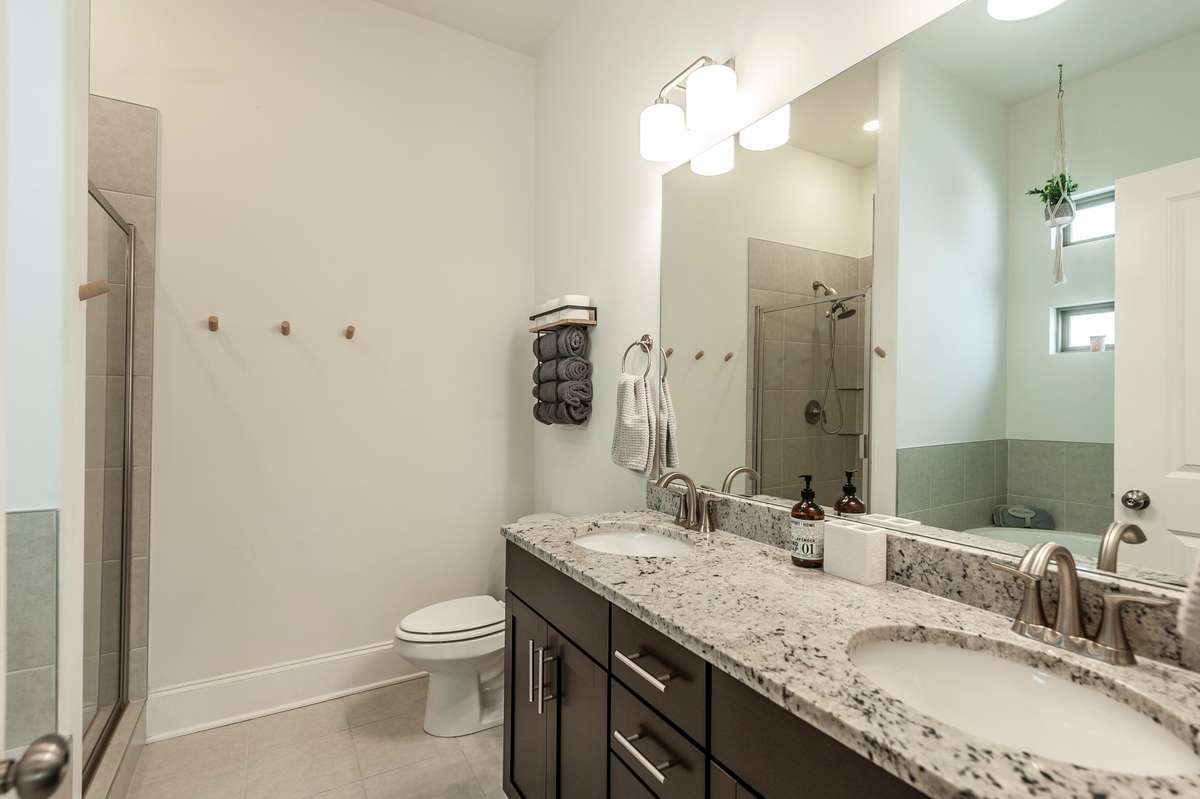 In the en-suite primary bathroom, you'll find a double vanity and elegant fixtures and counters!
