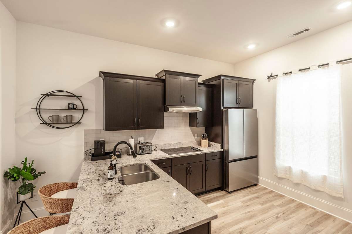 There is plenty of counter space for prepping or dining, as well as an open space for moving around easily in the kitchen while preparing meals!