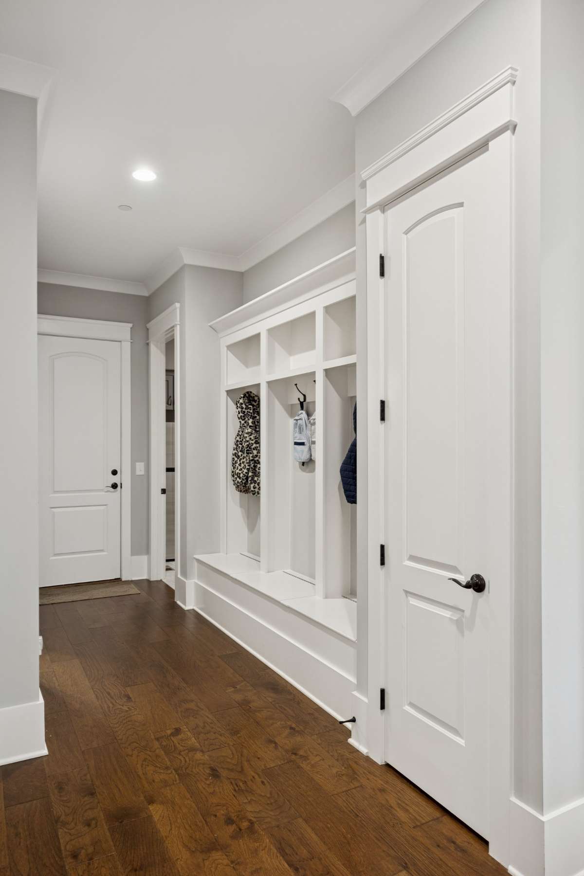 Designed for convenience, the home includes a custom drop zone off the garage and a spacious laundry room with ample storage.