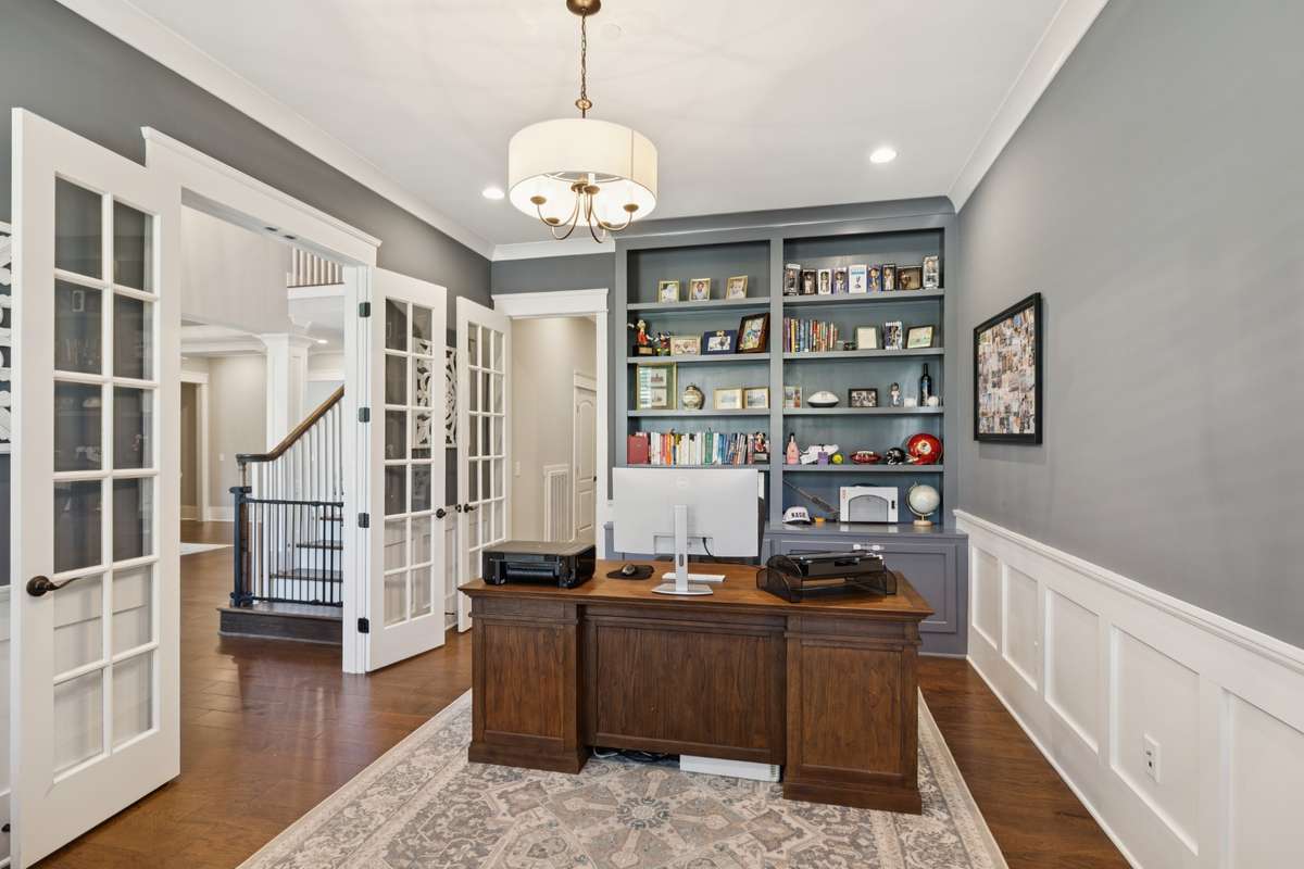 Just off the foyer, a private study with French doors and custom built-ins provides the perfect work-from-home retreat.