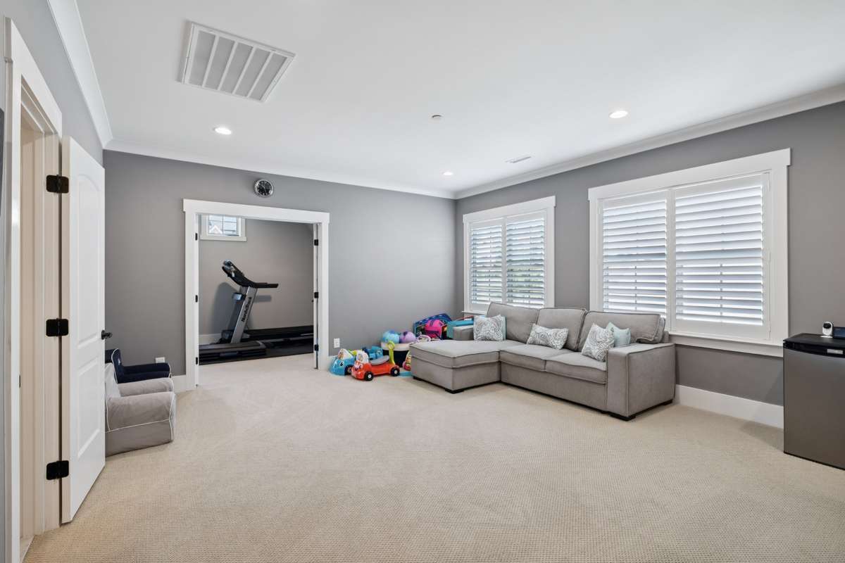 Upstairs, each additional bedroom includes its own en suite bath, while a generous bonus room provides flexible space for a media room, playroom, or fitness room.