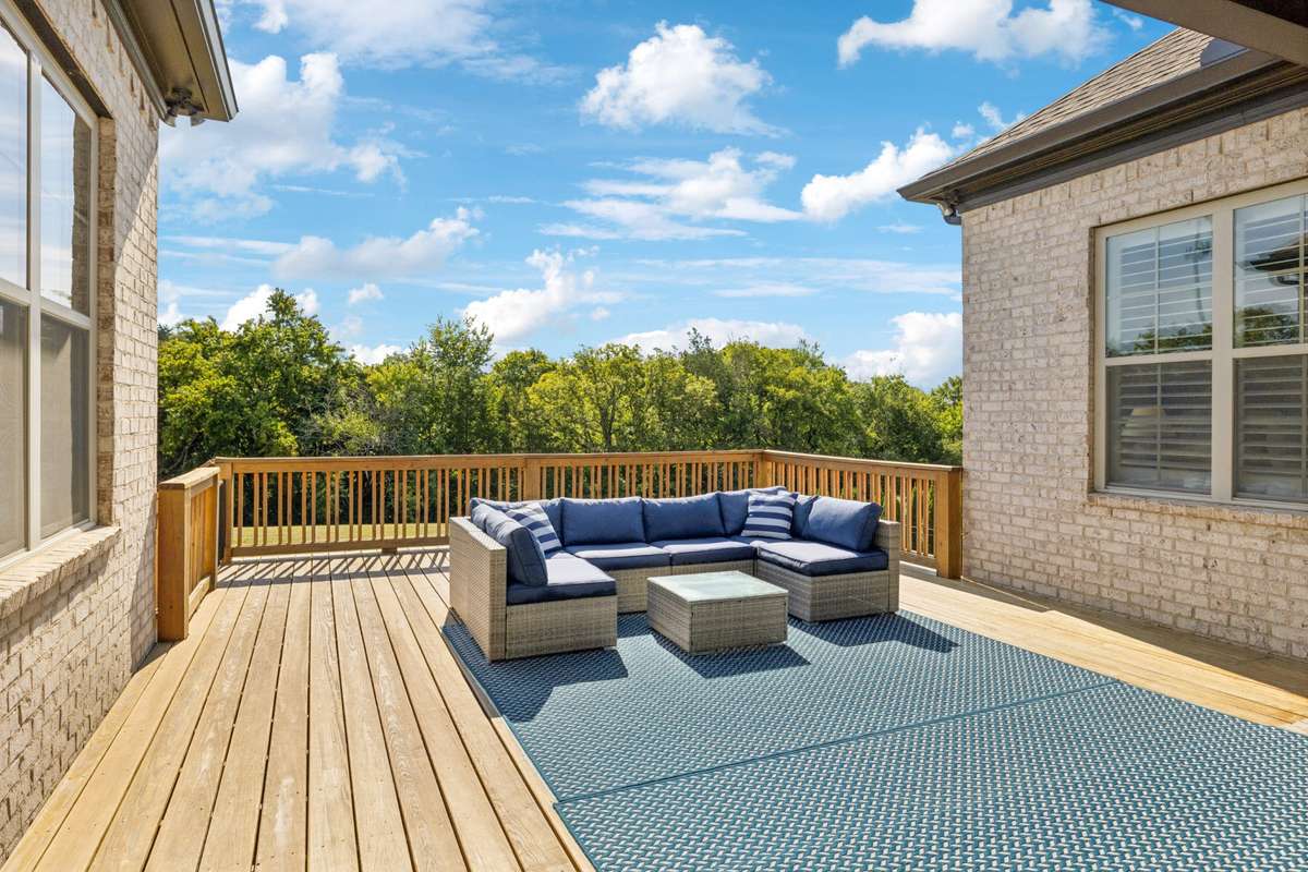 Outdoor living is just as inviting, with a partially covered deck overlooking the landscaped backyard.