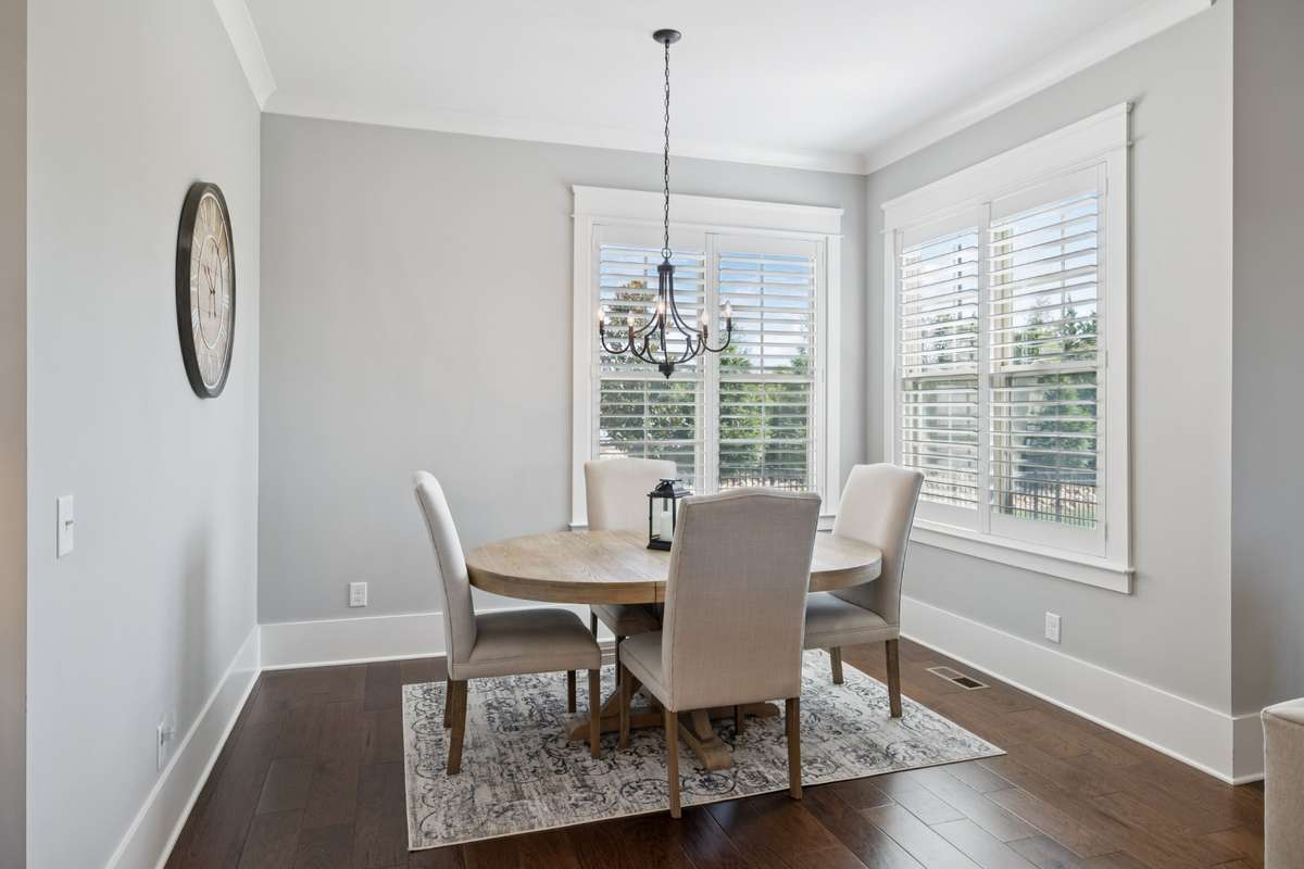 A cozy breakfast nook and nearby dry bar with beverage cooler make entertaining both easy and inviting.