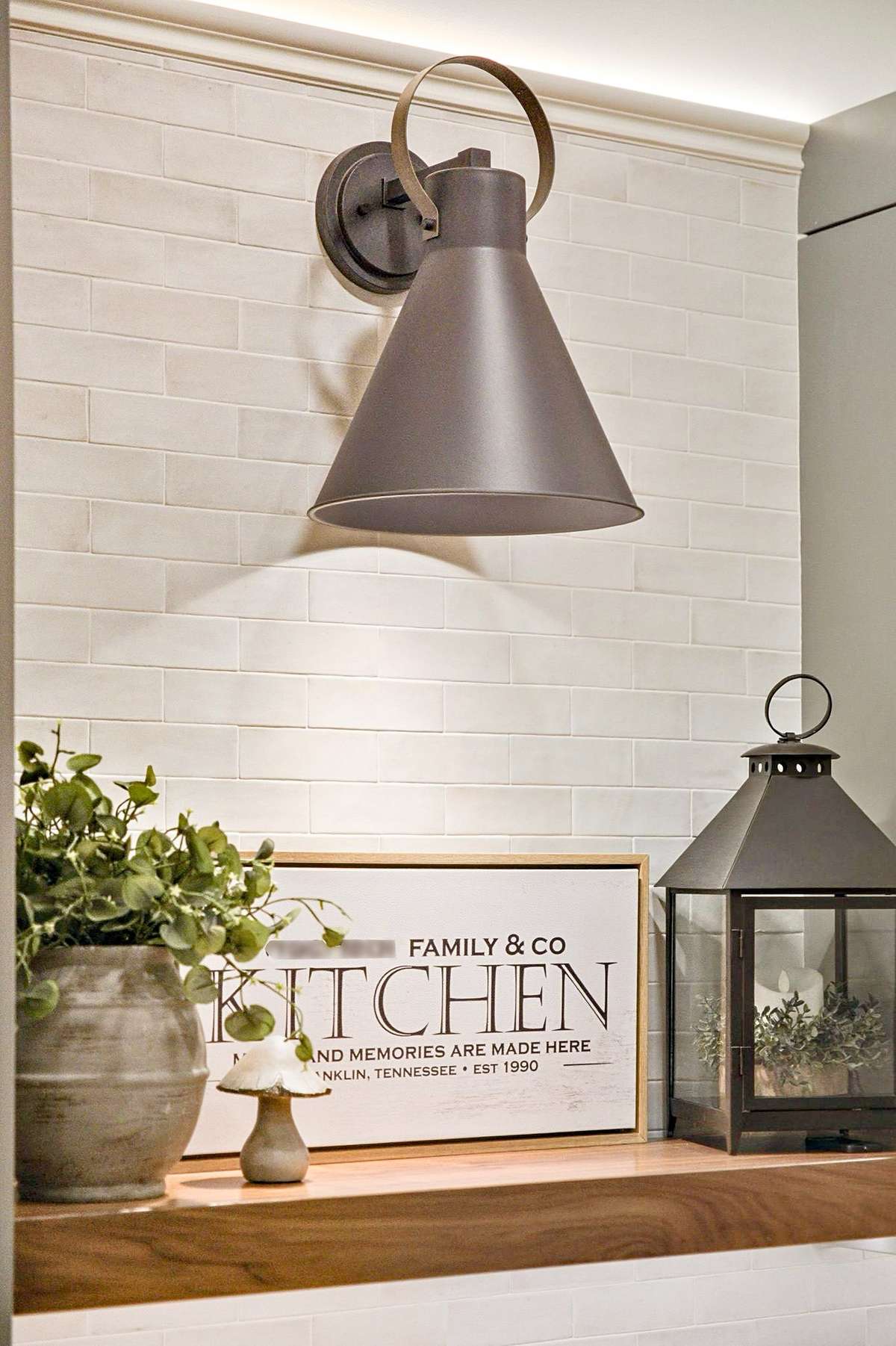 Accent lighting above and below the cabinets, as well as designer sconces bring this kitchen to life.