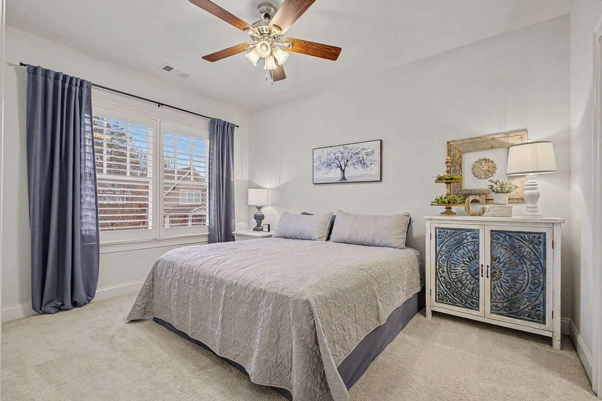 One of two front upstairs bedrooms, this one with a private full bath. Walk-in closet.