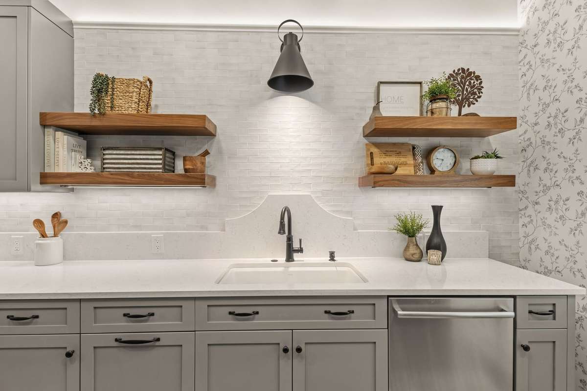 Secondary prep sink and custom walnut open shelving.