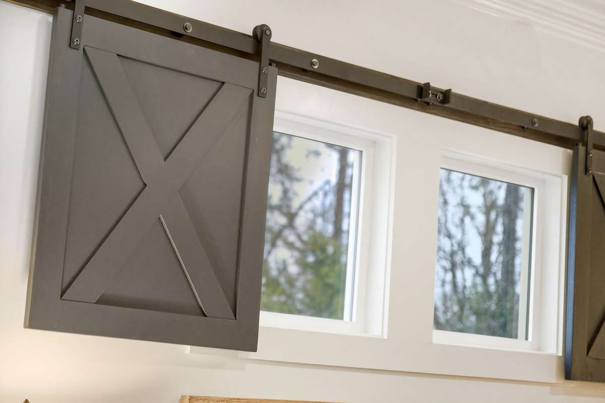 Love this detail of rolling shutters on the living room privacy windows.