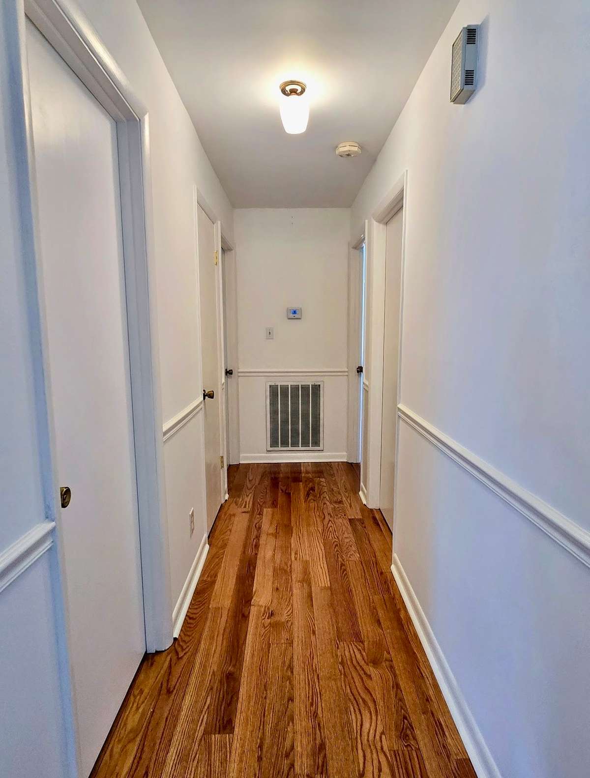 A view down the hallway toward the bedrooms and bathrooms.