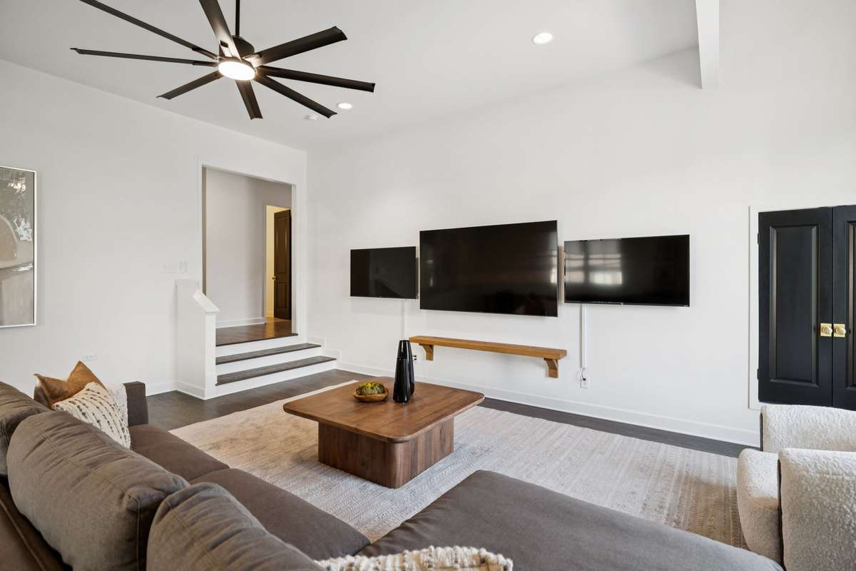 Spacious second-level bonus room filled with natural light, offering flexible living or media space. Includes three mounted TVs for immediate enjoyment.