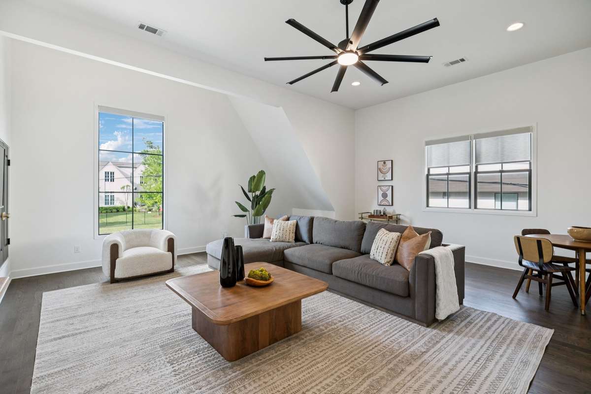 Spacious second-level bonus room filled with natural light, offering flexible living or media space. Includes three mounted TVs for immediate enjoyment.