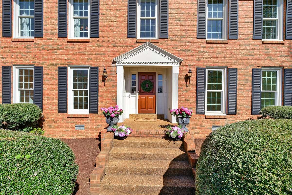 The covered porch and mahogany front door offers a warm and elegant welcome into the home.