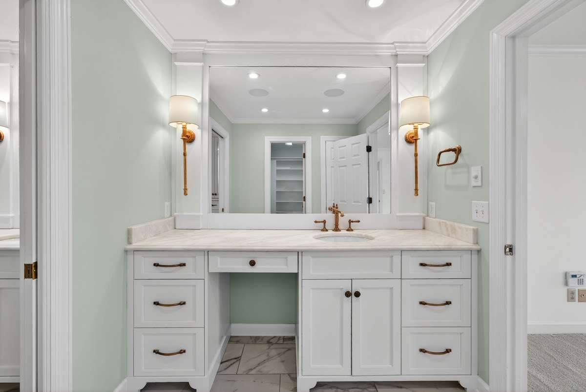 Beautifully designed ensuite bath offering marble countertop surfaces, heated floors, premium fixtures, as well as His and Hers vanities.
