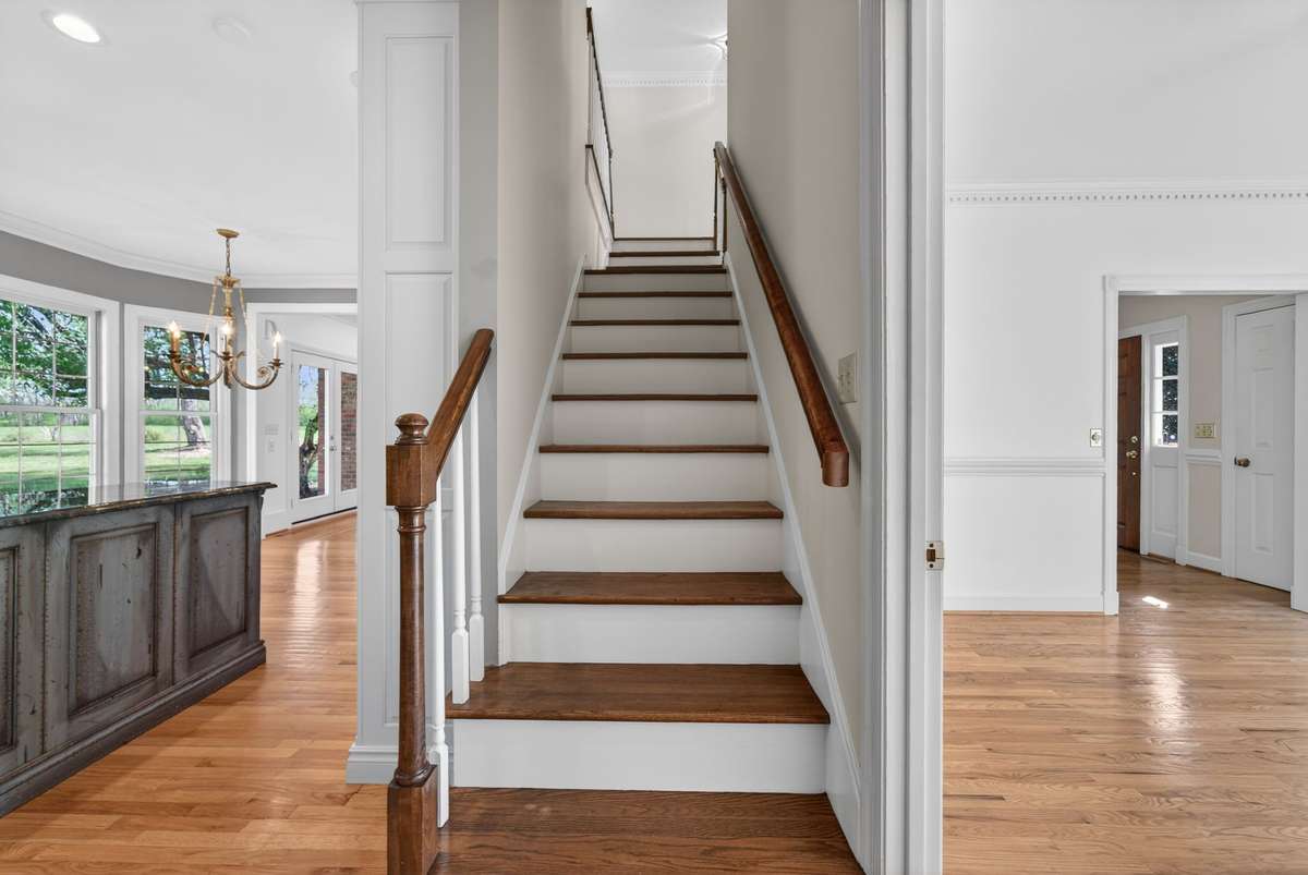 The rear staircase offers a private transition to three upstairs bedrooms.
