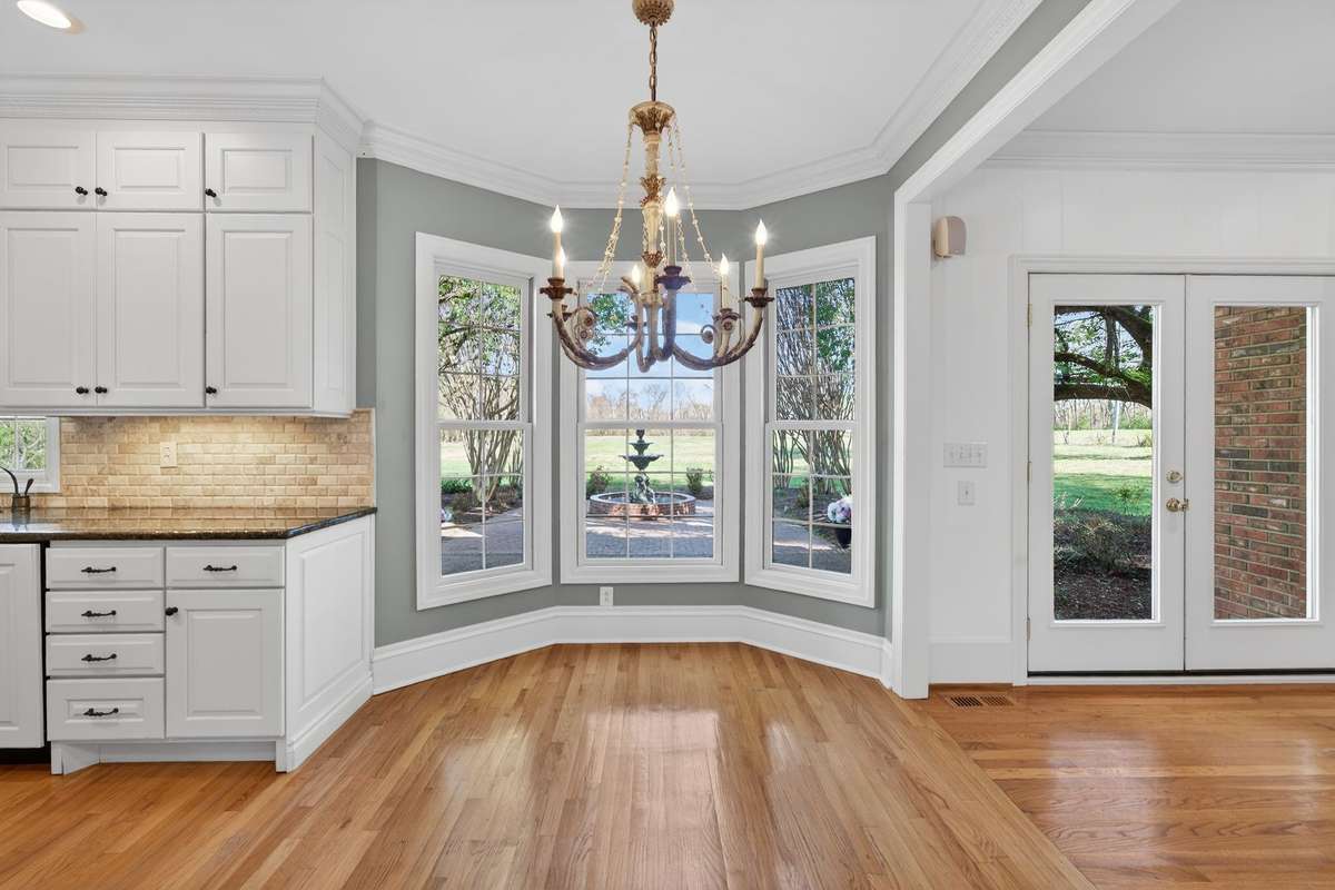 Breakfast nook with bay window offering beautiful views of the patio and fountain.