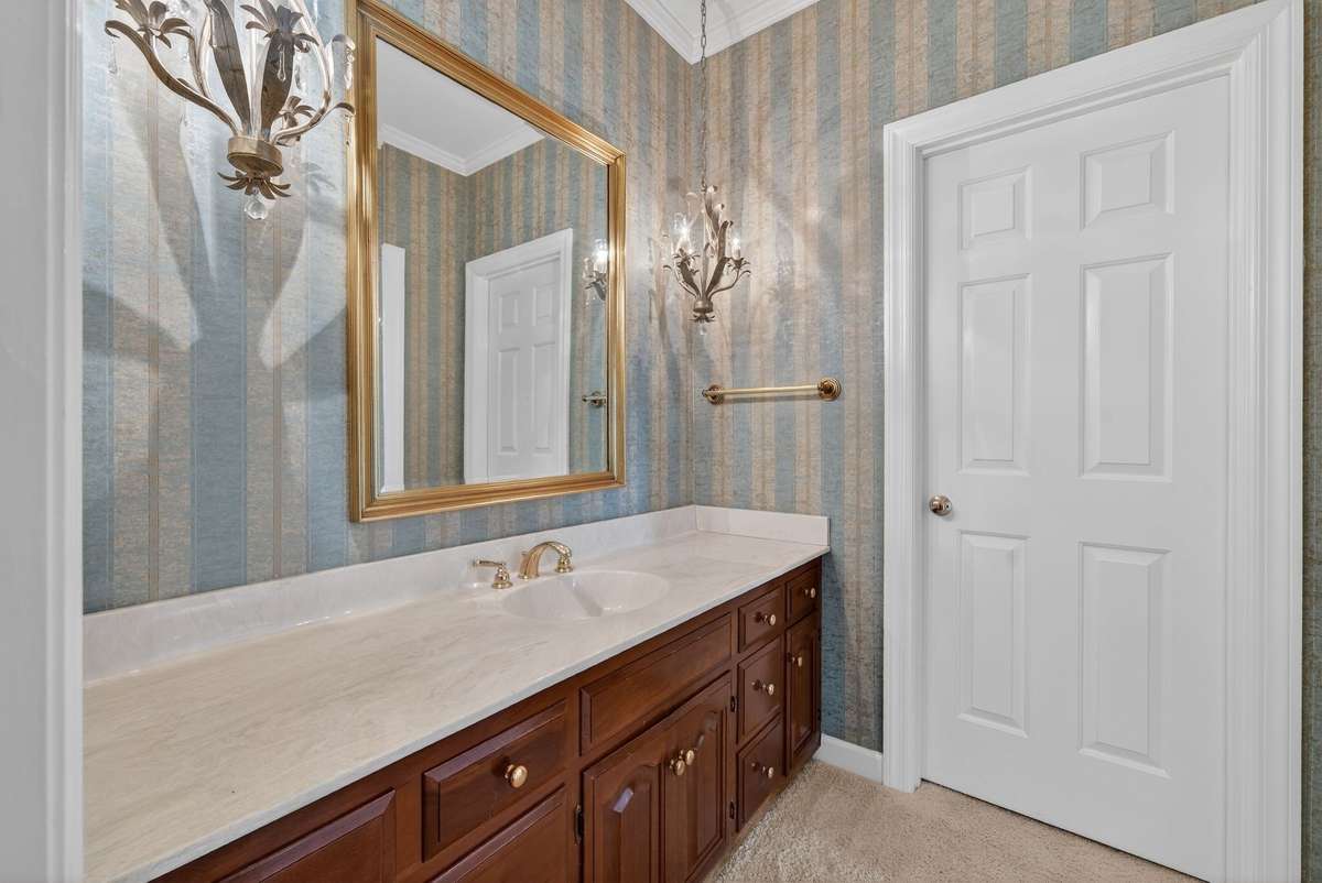 Main-level full bath designed to serve guest suite with ease.
