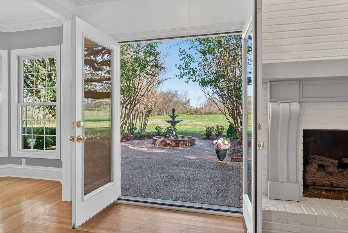 French doors frame a truly stunning fountain, creating a serene and elegant extension of the living space.