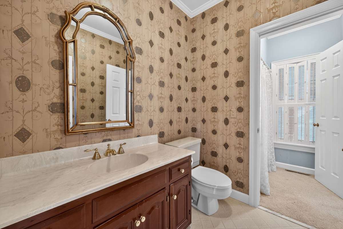 A well-placed main-level bath designed to serve the den and guest suite.