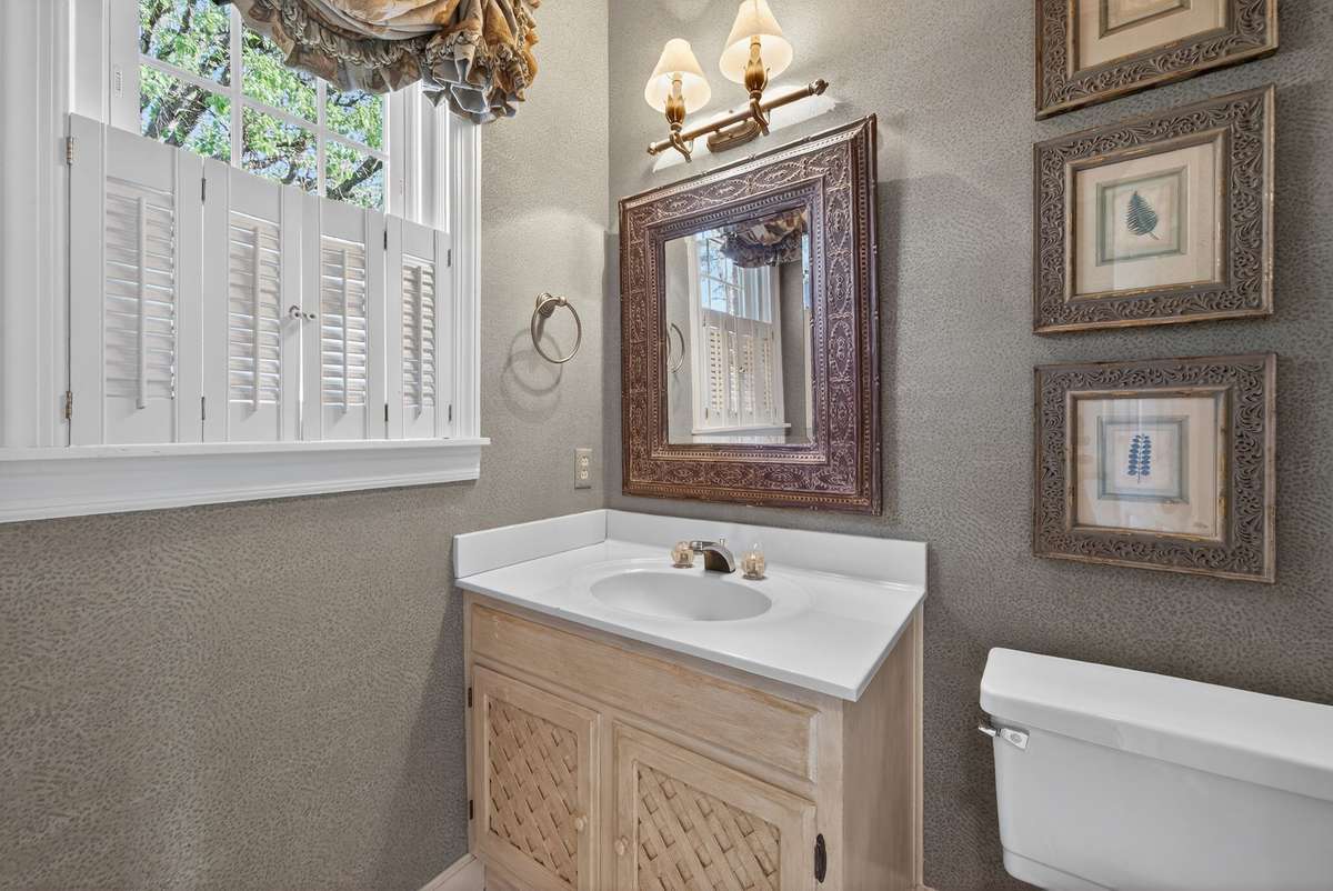 Powder room ideally situated off the sunroom, garage, and bonus area.
