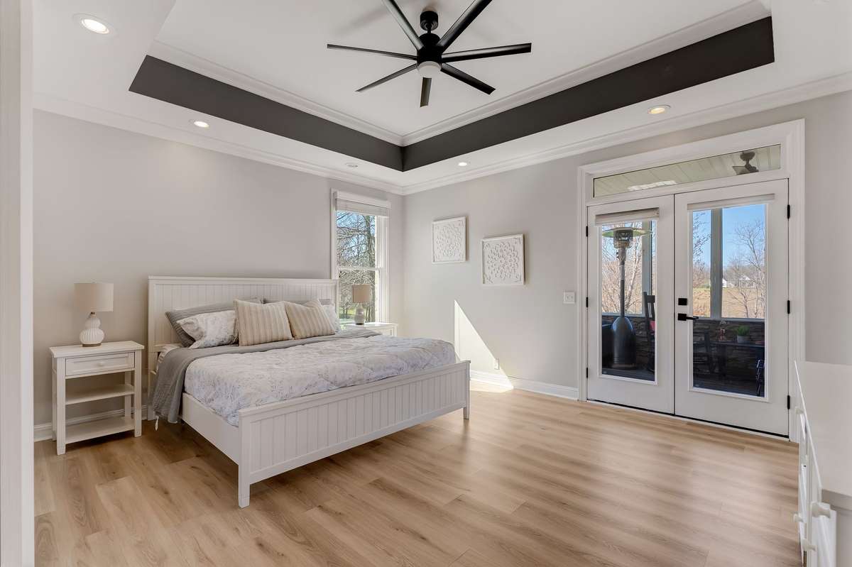 Large primary suite with plenty of space for a king-size bed and additional furniture, filled with natural light.
