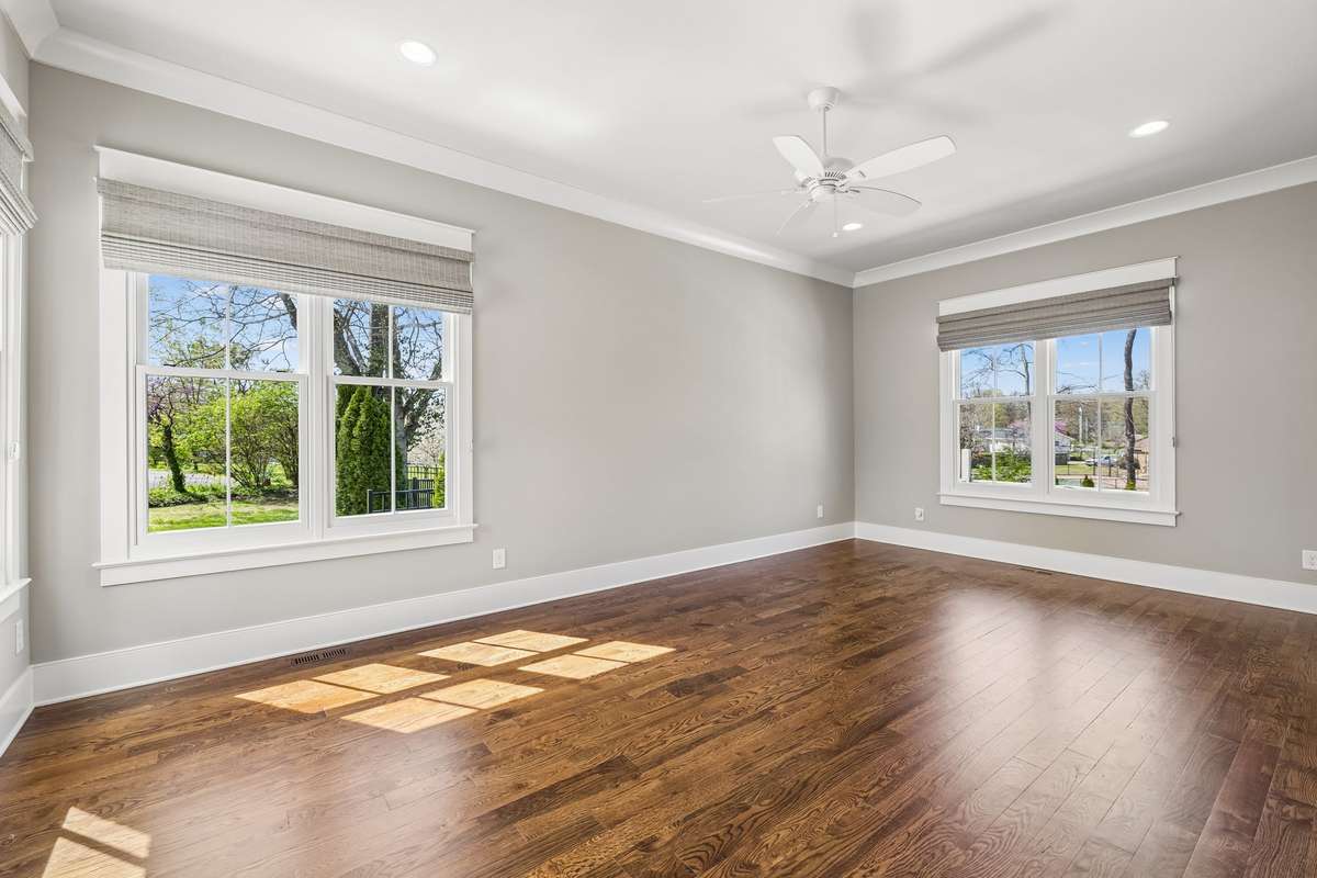The main level features four spacious bedrooms, each with en suite baths and walk-in closets, offering both privacy and convenience.