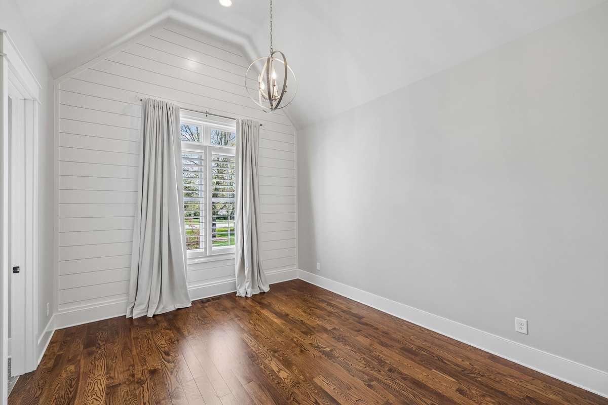 The main level features four spacious bedrooms, each with en suite baths and walk-in closets, offering both privacy and convenience.