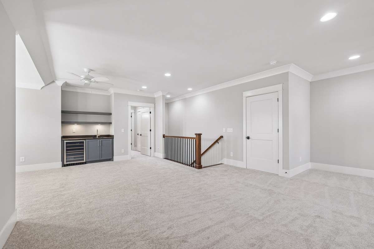 Upstairs, a spacious bonus room offers even more flexibility, featuring its own wet bar, beverage fridge, and granite countertops—perfect for movie nights, game days, or hosting guests.