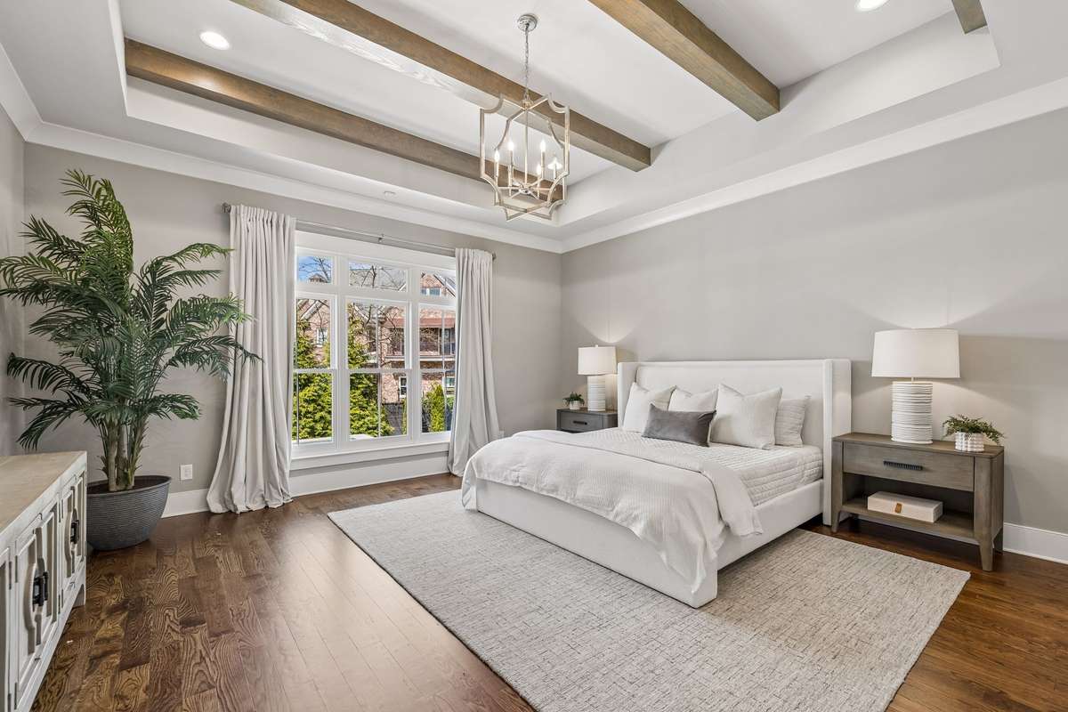 The primary suite is a true retreat, filled with natural light and detailed with a tray ceiling.