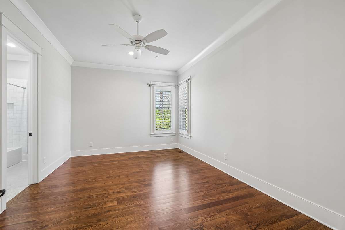 The main level features four spacious bedrooms, each with en suite baths and walk-in closets, offering both privacy and convenience.