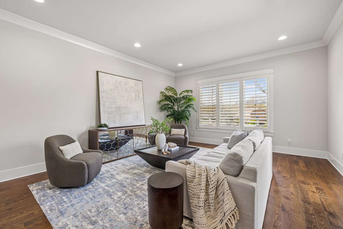A den or pool lounge with French doors opens directly to the backyard, where the lifestyle truly shines.