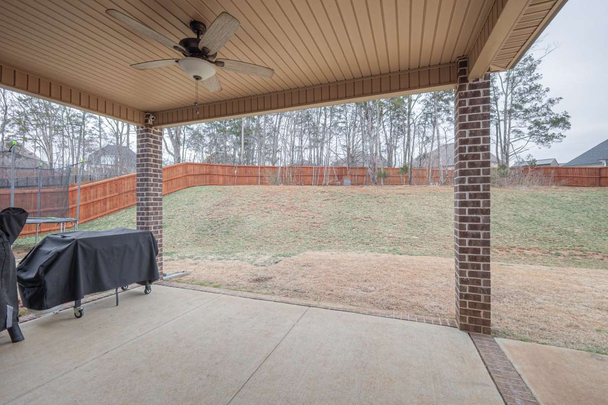 This yard is HUGE! Enjoy the shade of your covered patio while outside.